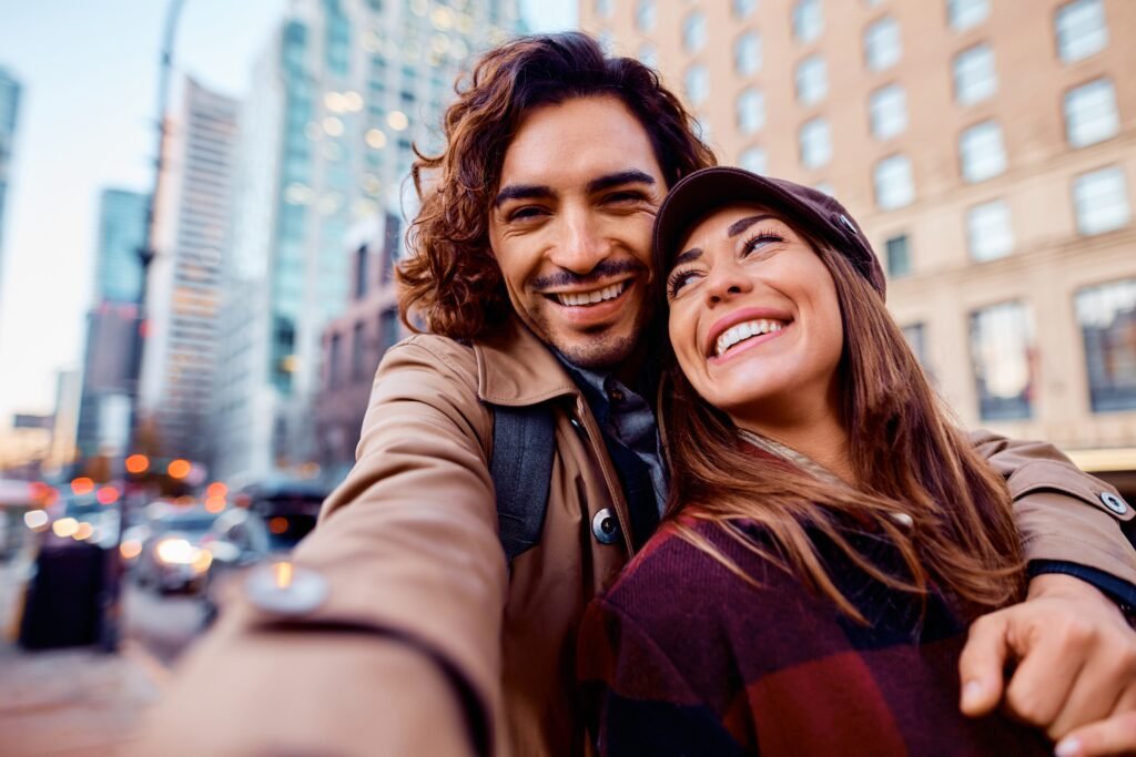 happy,latin,american,man,taking,selfie,with,his,girlfriend,on